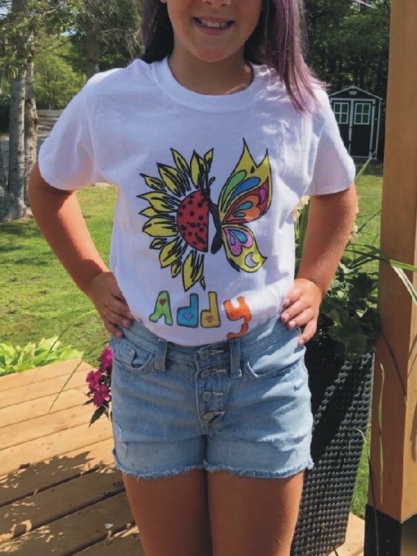 girl wearing finished colouring t-shirt