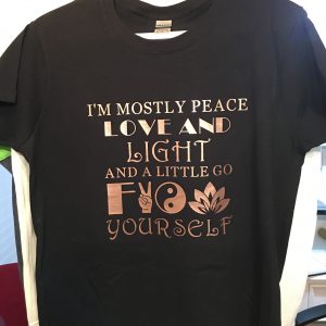 mostly peace love and light in metal HTV on a black t-shirt