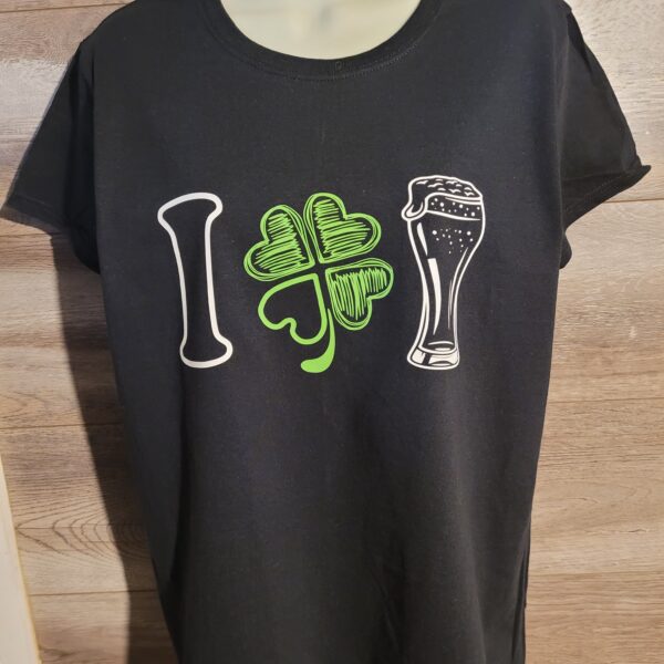 St. Patrick's Day themed ladies black custom t-shirt on a body form with I love booze in graphics across the chest