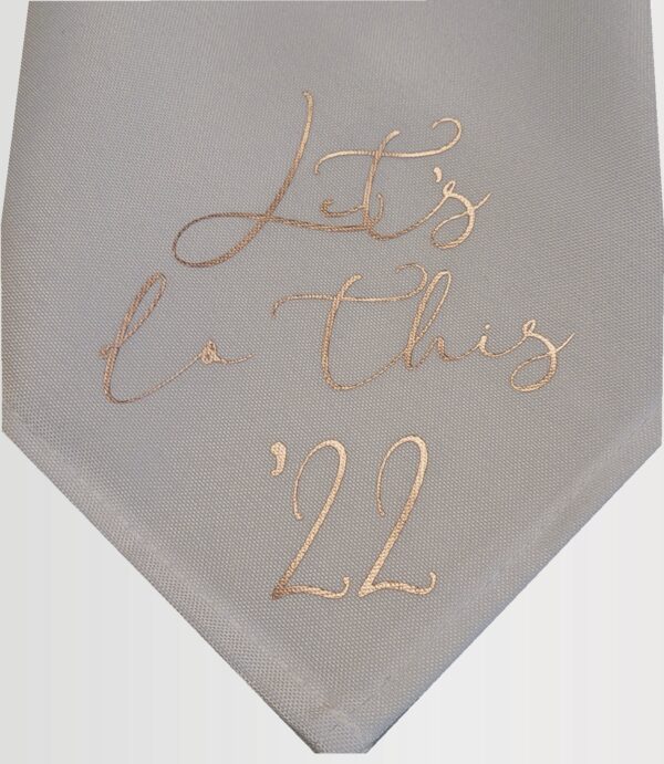sample of personalized white napkin with rose gold lettering