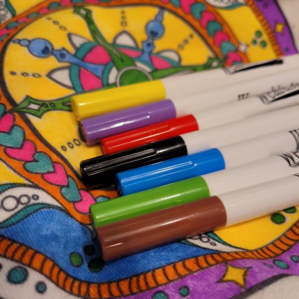 close up of fabric markers green, purple, brown, black, red, blue, yellow