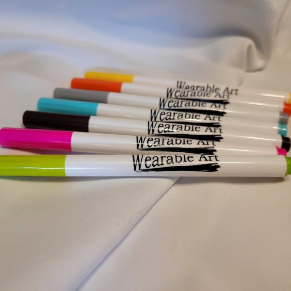 close up of fabric markers green, pink, black, blue, grey, orange, dark yellow